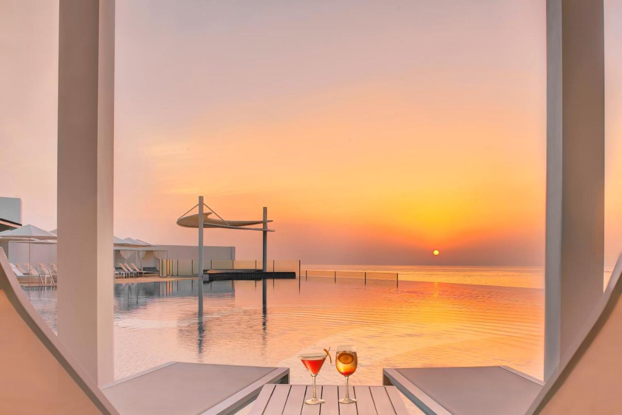 Royal M Al Aqah Beach Resort By Gewan Ngoại thất bức ảnh Sunset at the pool